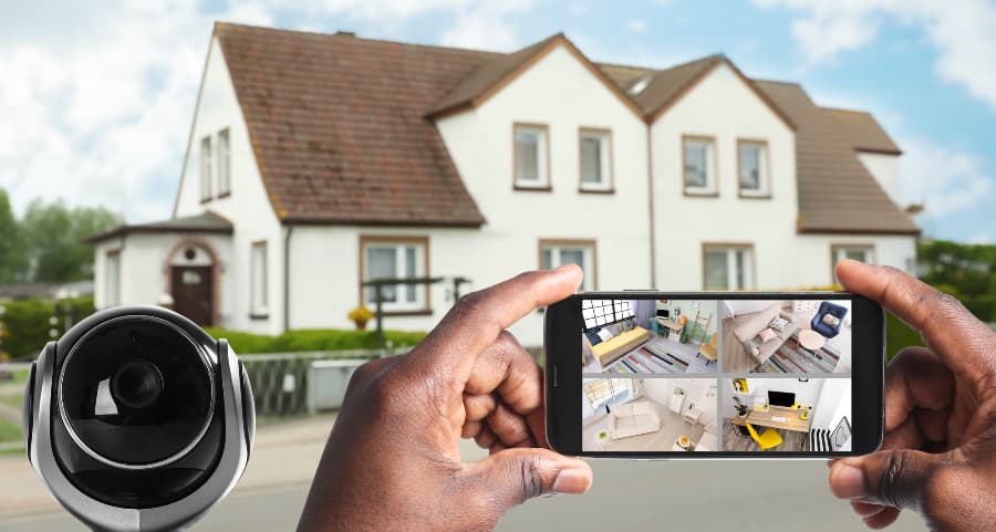 Man holding phone and looking at streams from video cameras